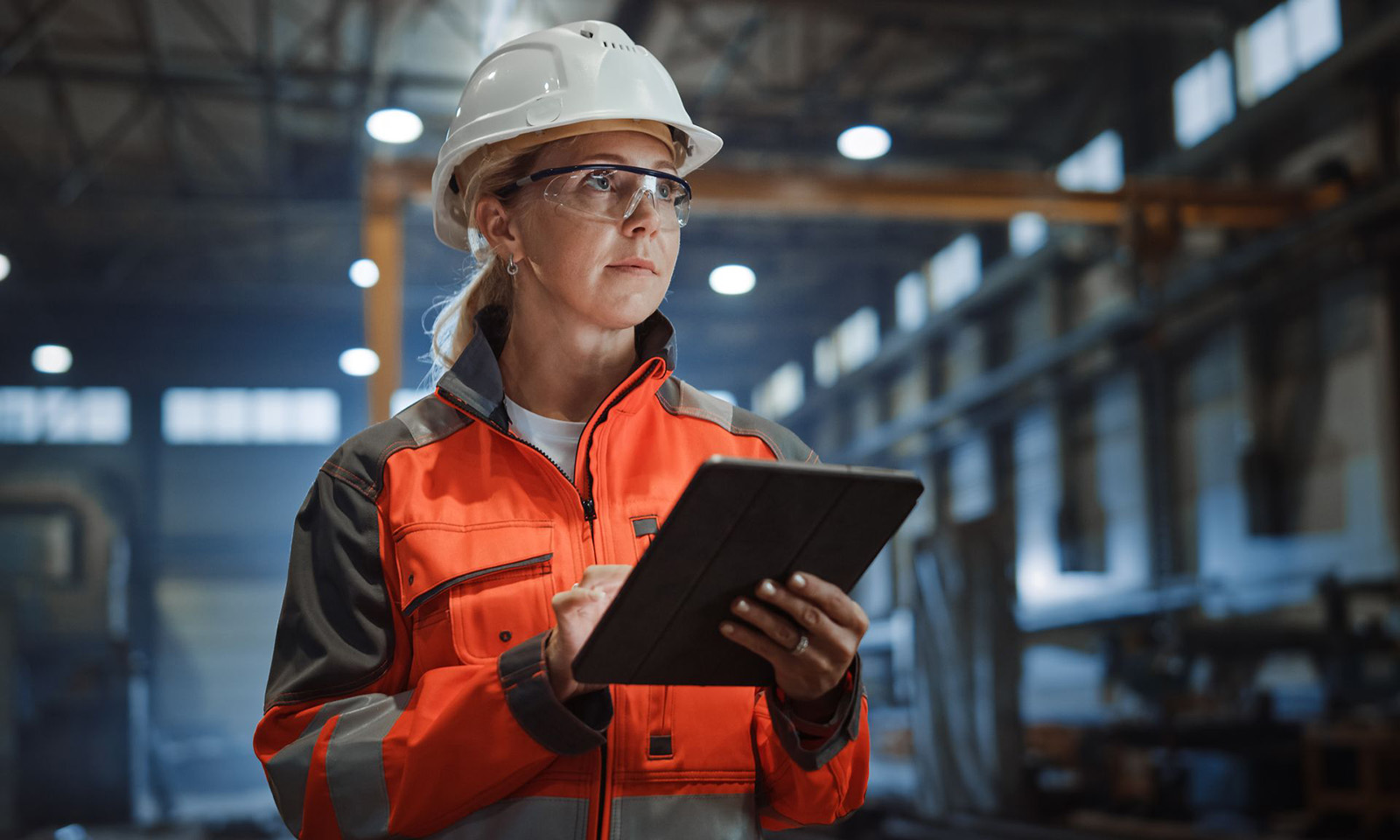 commitment-to-excellence Worker holding a clipboard in a warehouse